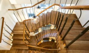 American Cherry wood handrail and treads offset against stone staircase, Welbeck Street, Mayfair by PT Handrails at Clive Durose staircase company