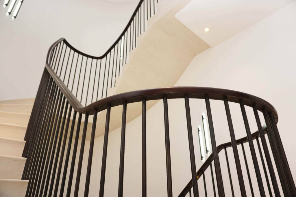 Bannister and handrail, multiple joins, in American Black Walnut by PT Handrails at Clive Durose Staircase Project @ Cadogan Square, Chelsea