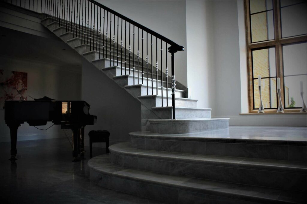 Natural Wooden Handrail System, elegant spindles on marble staircase, installed at Lower Farm, Gloucestershire, by PT Handrails @ Clive Durose