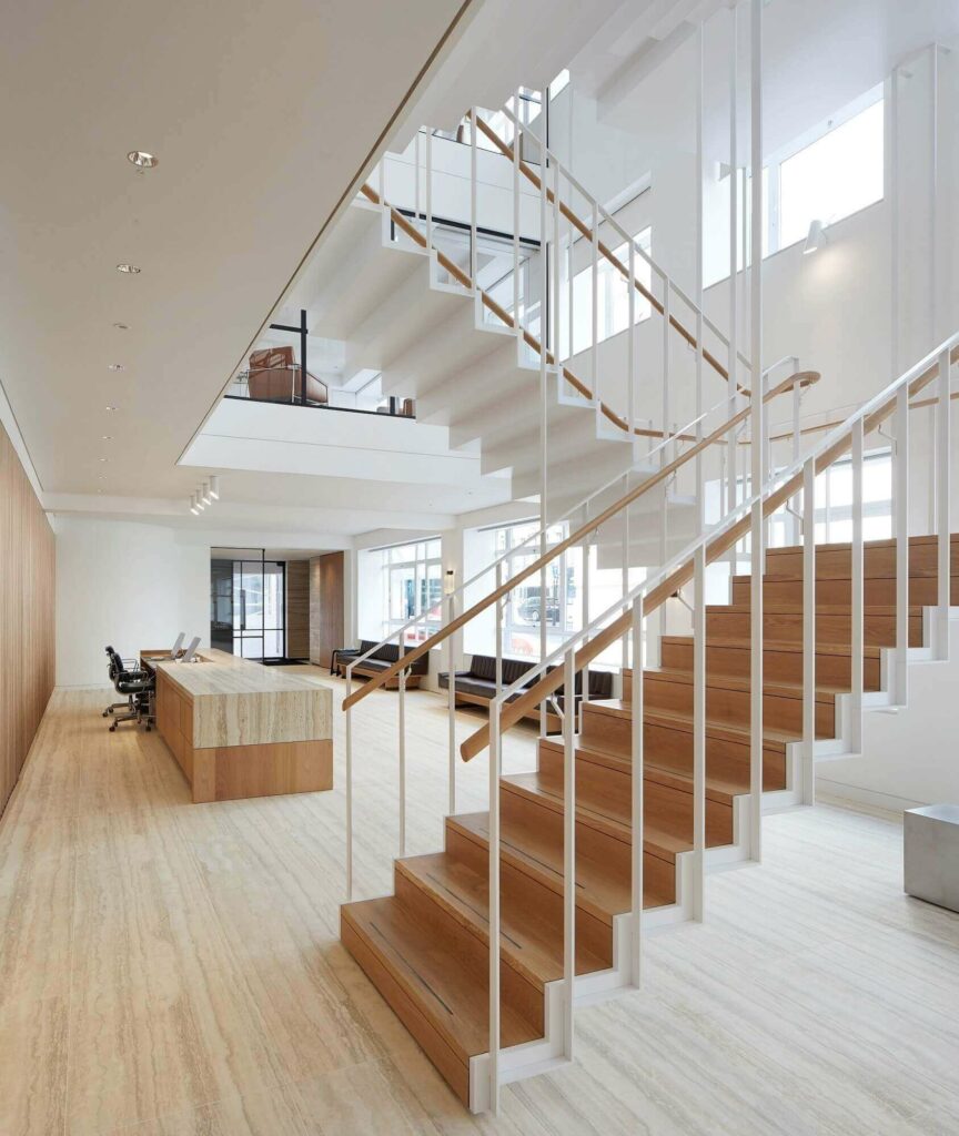Savile Road commercial staircase natural wood handrail multi floor view, like floating steps, by PT Handrails at Clive Durose